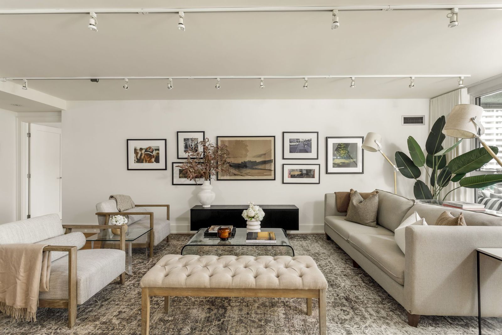 A living room with a gallery wall and layered seating, Bloor Street East