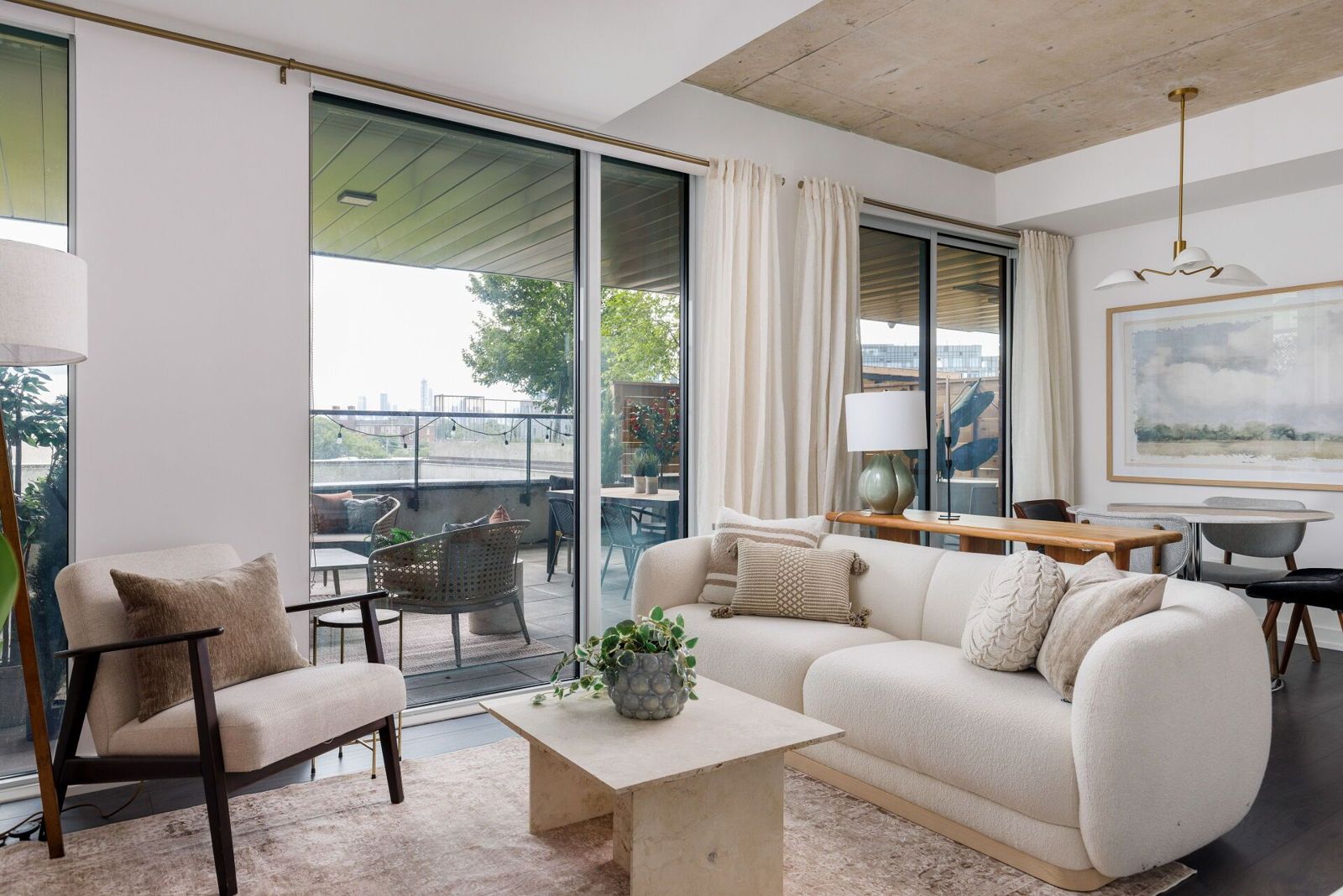 Living area with a full sofa and the terrace doors beyond