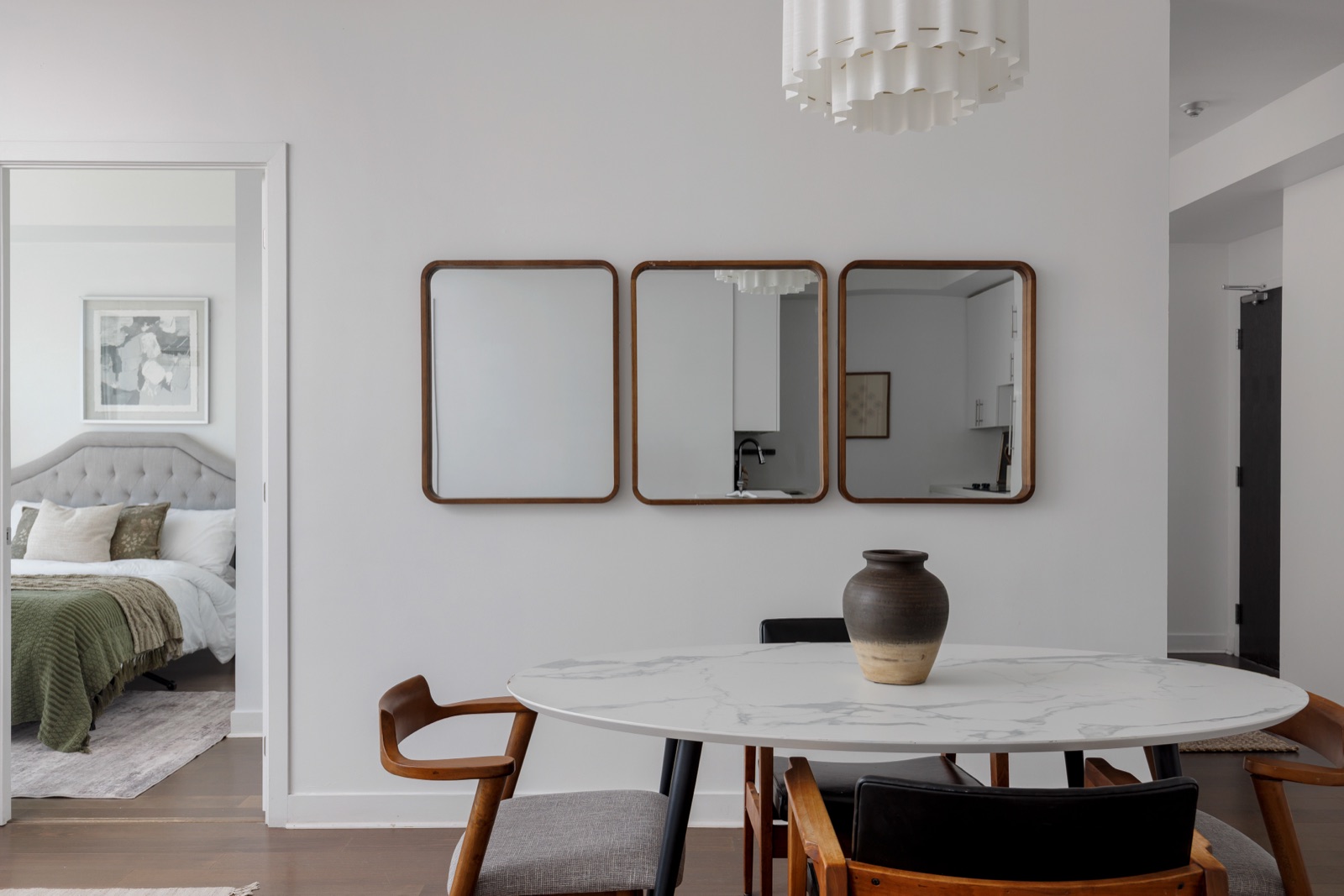 Dining area with three walnut mirrors and the marble table