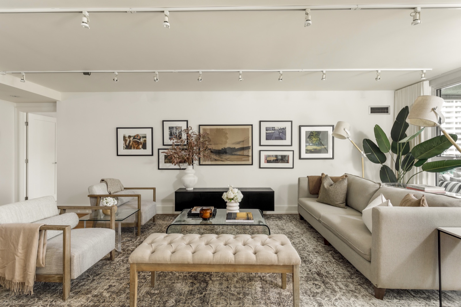 Long living room with the gallery wall and tufted bench