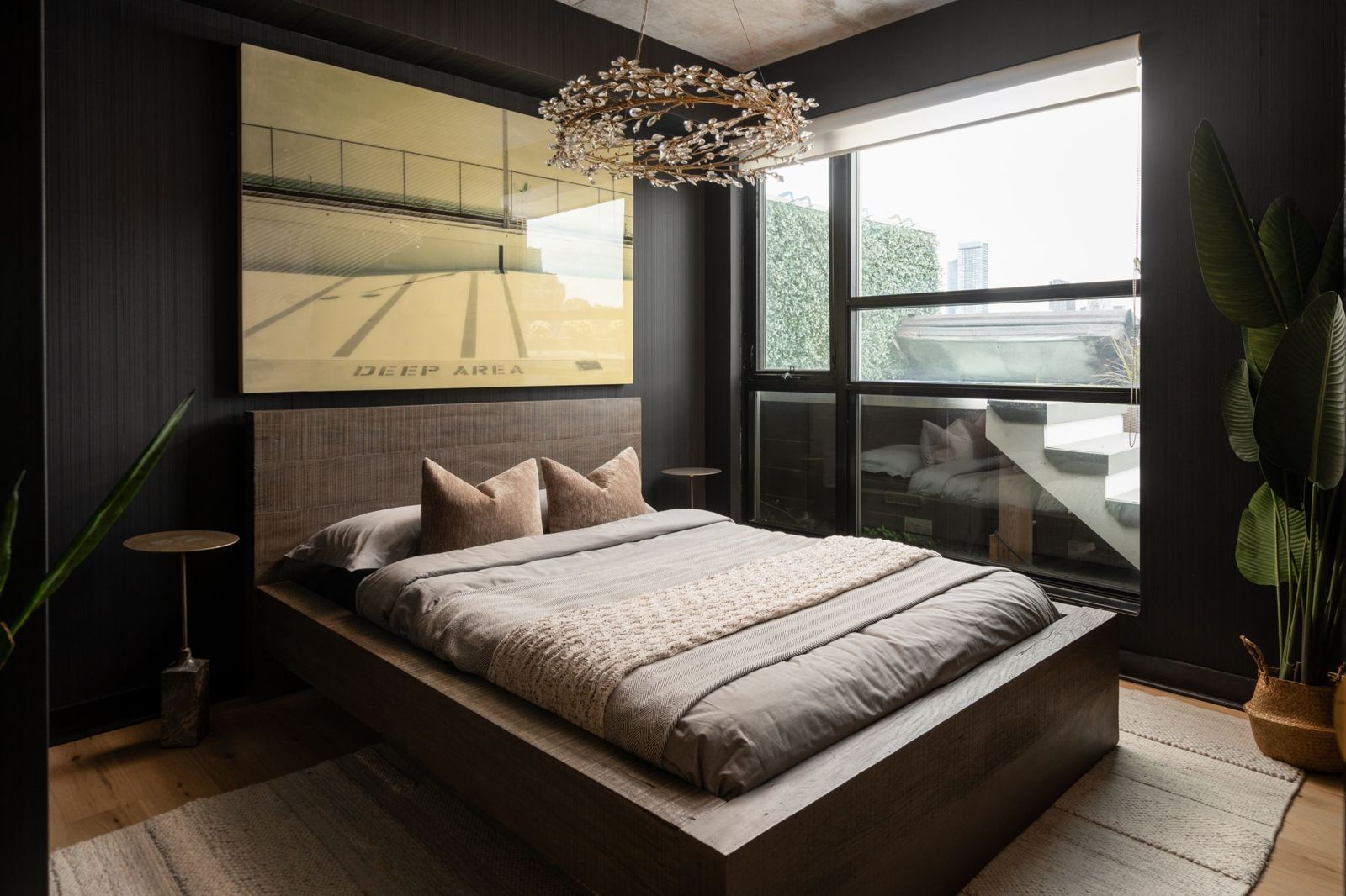 Primary bedroom with dark panelled walls